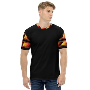 May include: A black t-shirt with a geometric pattern in shades of red, orange, and yellow on the sleeves and neckline.