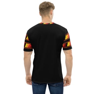 May include: Black short-sleeved t-shirt with a geometric pattern in red, yellow, and orange on the sleeves.