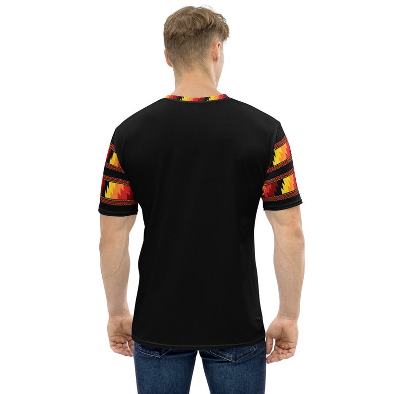 May include: Black short-sleeved t-shirt with a geometric pattern in red, yellow, and orange on the sleeves.