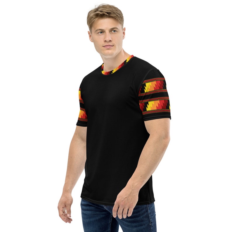 May include: Black short-sleeved t-shirt with a geometric pattern in red, orange, and yellow on the sleeves.