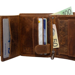 May include: A brown leather wallet with a zipped compartment, multiple card slots, and a flap with a snap closure. The wallet has the text "RFID SAFE" and "Hand Made Full Grain Leather" printed on it. The wallet is open and contains cards and cash.