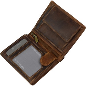 May include: A brown leather wallet with a zipped pocket and multiple card slots. The wallet is open and the interior is visible. The words "CREDIT CARD" are printed on the card slots.
