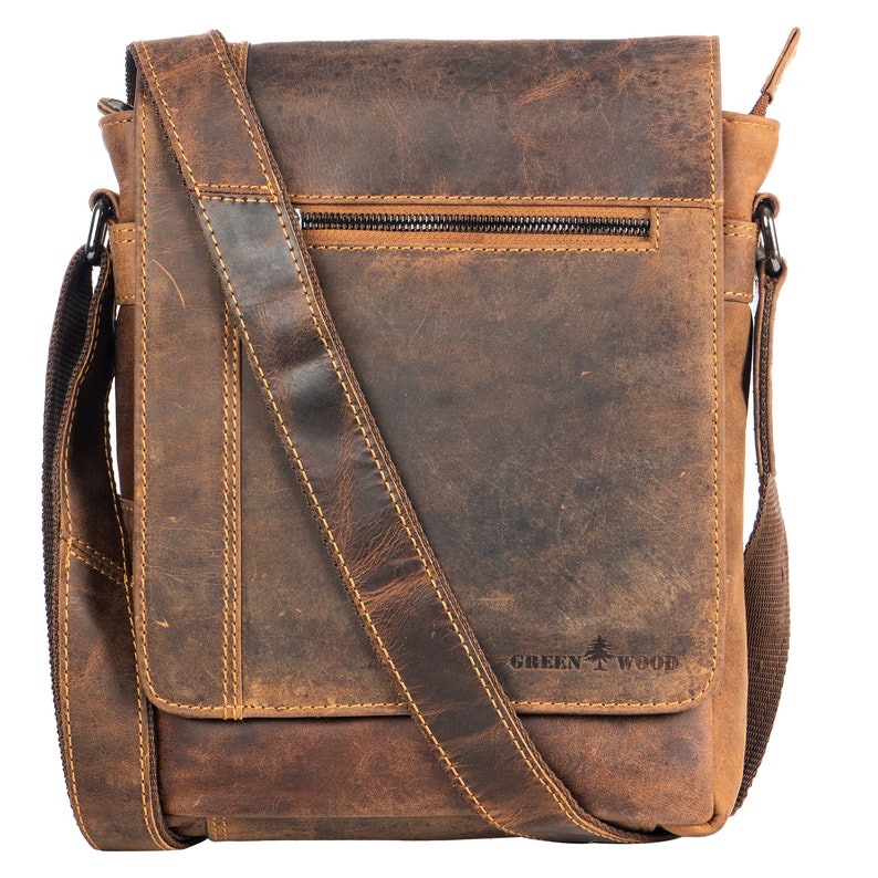 May include: A brown leather messenger bag with an adjustable strap and a zippered pocket. The bag has a distressed look and the brand name "GREEN WOOD" is embossed on the front.