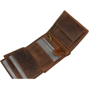 May include: A brown leather trifold wallet with multiple card slots and a zipped compartment. The wallet is open and shows the interior with several credit cards inserted.