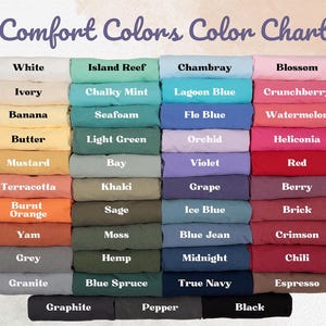 May include: A color chart titled "Comfort Colors Color Chart" displays a variety of fabric colors. The chart includes shades like white, ivory, banana, butter, mustard, terracotta, burnt orange, yam, grey, granite, island reef, chalky mint, seafoam, light green, bay, khaki, sage, moss, hemp, blue spruce, chambray, lagoon blue, flo blue, orchid, violet, grape, ice blue, blue jean, midnight, true navy, blossom, crunchberry, watermelon, heliconia, red, berry, brick, crimson, chili, espresso, graphite, pepper, and black.