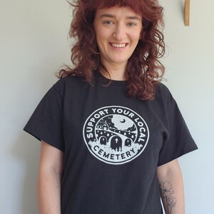 K wears the cemetery shirt in size medium.  Sizes are relaxed fit.