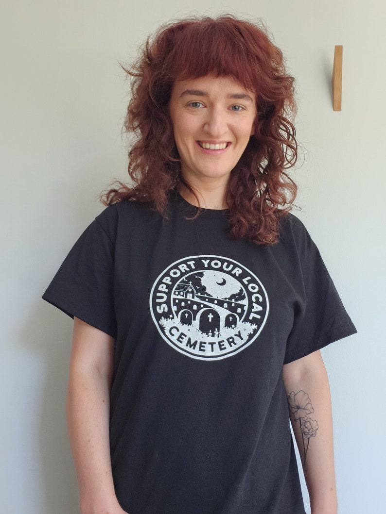 K wears the cemetery shirt in size medium.  Sizes are relaxed fit.