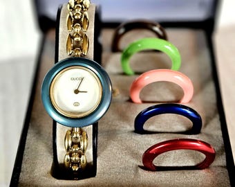 Authentic 18k Gold Plated Gucci Bezel Watch in Excellent Condition with a  6 3/4" Rice Link Bracelet and 6 Like New Bezels.