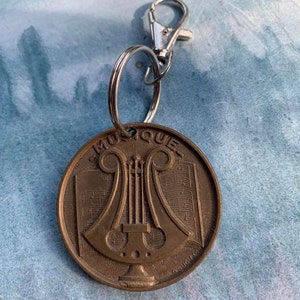 One vintage french medals by  minister 1959 signed solid bronze Music medal  Harpekey ring olive leaves flag france