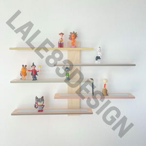 K&ouml;nnte beinhalten: Ein Satz von vier Holzregalen mit einer hellen Holzoptik. Die Regale sind an einer Wand montiert und mit verschiedenen Figuren dekoriert, darunter ein Cowboy, ein L&ouml;we, eine Hexe, ein Ritter und eine Comicfigur.