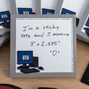 May include: A collection of sticky notes featuring a computer graphic. The central note states "I'm a sticky note and I measure 7.6cm x 7.3cm". A black SD card, a red mouse, and a pen are also visible.