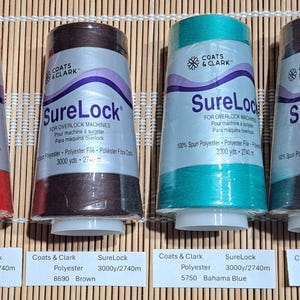 May include: Four spools of Coats & Clark SureLock thread for overlock machines. Colors include tomato red, brown, Bahama blue, and Oxford grey. Each spool contains 3000 yards (2740 meters) of polyester thread.