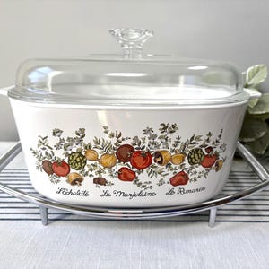 May include: A set of three ceramic mugs with a speckled, matte finish. The mugs are in shades of cream, light gray, and dark gray. Each mug has a simple, minimalist design and a rounded handle. The mugs are stacked on top of each other.