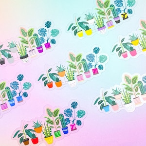 May include: Clear stickers featuring a variety of potted plants in colorful pots. The stickers include illustrations of monstera, cactus, and other houseplant varieties. The background is a gradient of pink and blue.