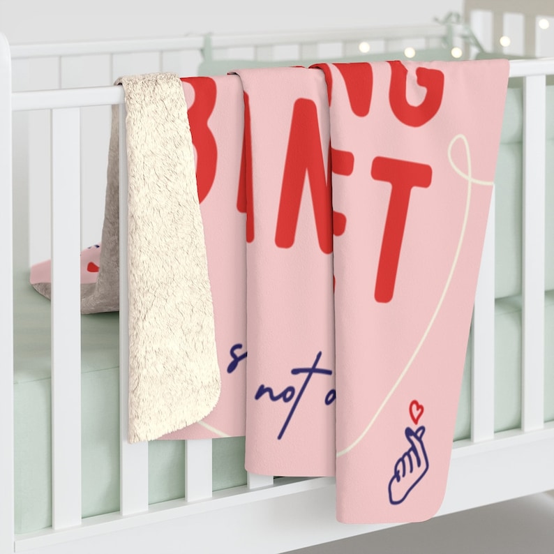 May include: Pink fleece blanket with a red heart and the text "Being a parent is not a job it's a lifestyle" in white text.
