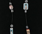 Empowered Women Necklace with handmade polymer clay beads of women’s faces and black and white designs