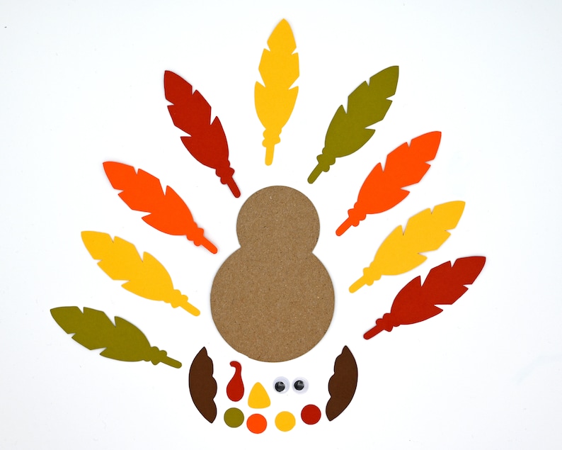 May include: Craft supplies for making a Thanksgiving turkey. The kit includes a brown paper body, colorful felt feathers, googly eyes, a beak, and a wattle.