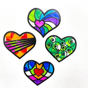 May include: Four colorful heart-shaped decorations with different patterns. The hearts are made of paper and have a stained glass look. The patterns include swirls, stripes, and geometric shapes.