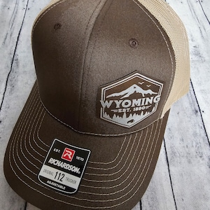 May include: Brown and tan trucker hat with a white patch that says "Wyoming Est. 1890" and a red and white Richardson 112 label.