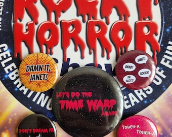 May include: A collection of six circular buttons with text from the musical "The Rocky Horror Picture Show." The buttons feature phrases like "Damn it, Janet!" and "Let's do the Time Warp Again." The background includes the show's logo.