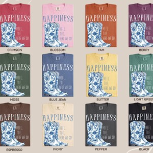 May include: A selection of Comfort Colors 1717 T-shirts in a range of colours, each displaying a blue and white floral cowboy boot graphic and the word "HAPPINESS". The text "HEEL TOE HERE WE GO" is also printed on the shirts.