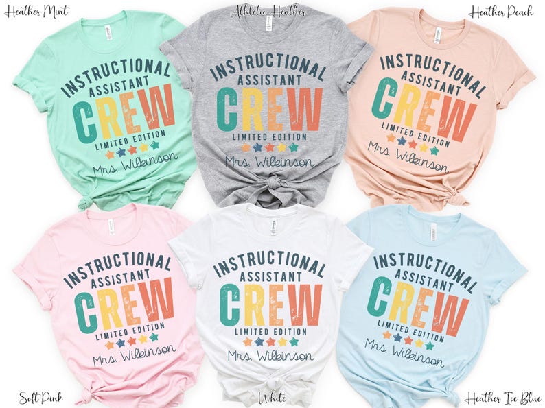 May include: A selection of t-shirts in shades like mint, grey, peach, pink, white, and pale blue. Each shirt displays the text "INSTRUCTIONAL ASSISTANT CREW LIMITED EDITION" in a retro style, with "Mrs. Wilkinson" printed beneath the design.