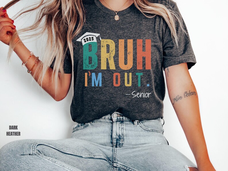May include: Dark heather grey t-shirt with a rainbow graphic that says "BRUH I'M OUT. -Senior" and a graduation cap with the year 2025.