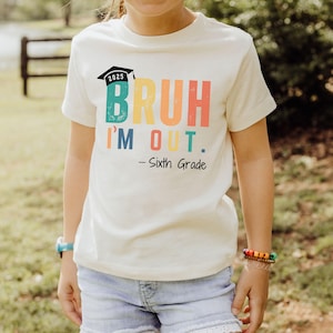 May include: White t-shirt with a rainbow colored graphic that says "Bruh I'm Out. - Sixth Grade" and a graduation cap with the year 2025 on it.