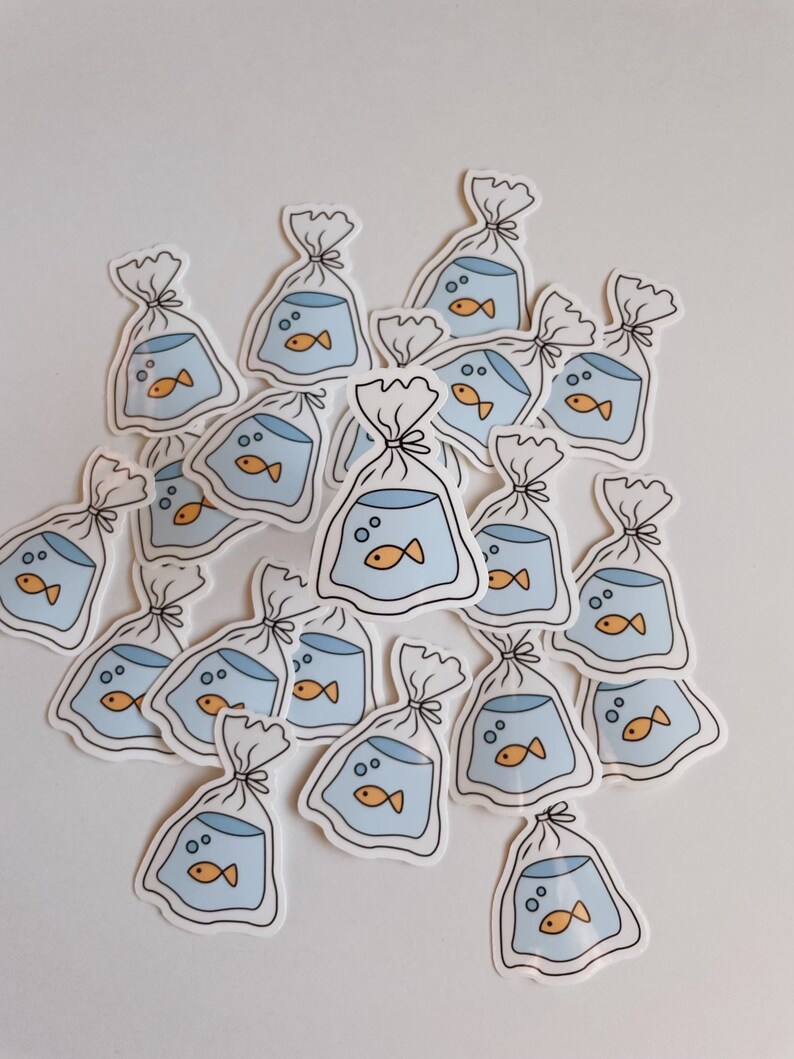 May include: A collection of stickers featuring a cartoon goldfish in a plastic bag. The stickers are white with blue and orange accents.