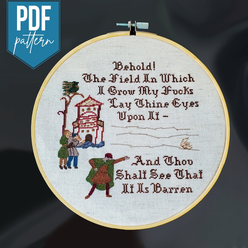 A wooden hoop with a cross stitched design of 3 people looking at a field with a house and bird in the background. Text reads: Behold! The Field In Which I Grow My Fvcks. Lay Thine Eyes Upon It - And Thou Shalt See That It Is Barren.