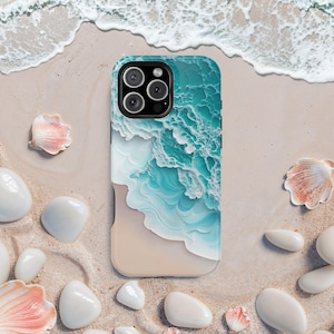May include: A phone case with a beach scene featuring blue waves crashing on a sandy shore. The case has a camera cutout with three lenses.