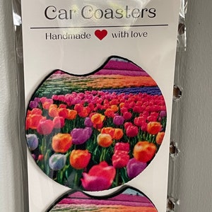 May include: Two round car coasters with a colorful tulip field design. The coasters are handmade with love.