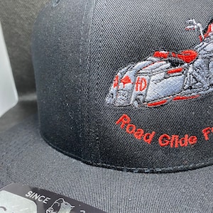 May include: Black baseball cap with an embroidered Harley Davidson motorcycle and the text "Road Glide For Life".