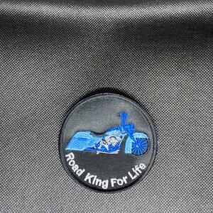 May include: A black and blue embroidered patch with a motorcycle and the text "Road King For Life".