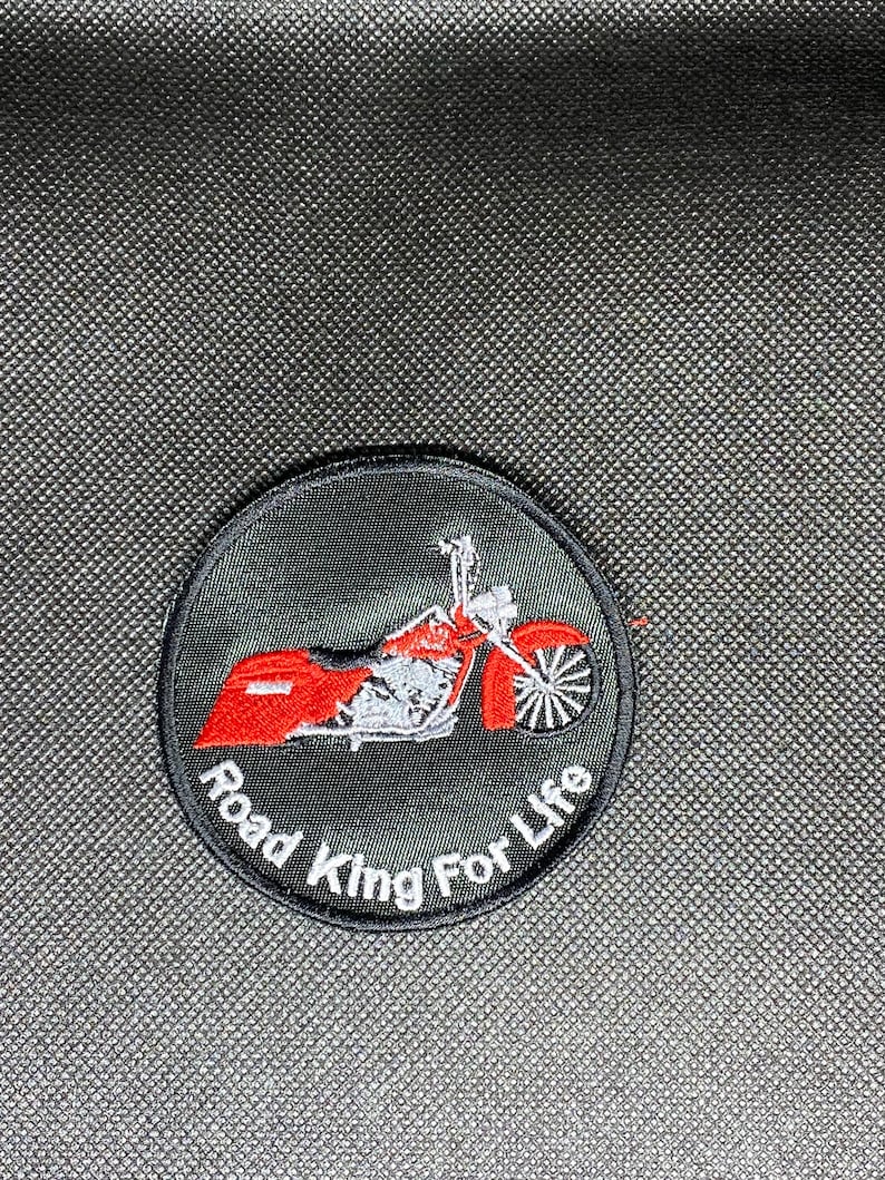 May include: A black and white embroidered patch with a red motorcycle and the text "Road King For Life".