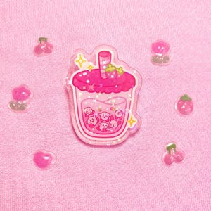Kirb-boba holographic acrylic pins | pins, boba, kirby, poyo, acrylic, strawberry, orange, cute, sparkles, drawing, stars, gold Strawberry boba