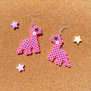 Pink dinosaur earrings | dinosaur, animal, dinosaur earrings, perler beads, perler bead earrings, dangle earrings, cute, pink