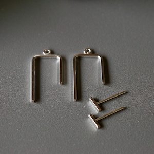 May include: Two silver earring blanks with a loop at the top and a straight bar at the bottom. Two silver earring posts with a straight bar at the top and a loop at the bottom.