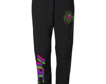 Può includere: Pantaloni della tuta neri con una grafica di ragno alieno verde e rosa sulla gamba destra e una grafica viola, verde e rosa sulla gamba sinistra.