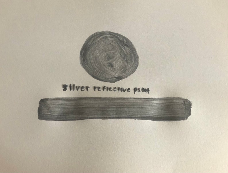 May include: A silver reflective paint swatch. The paint is shown in a circle and a long rectangle. The text "silver reflective paint" is written below the circle.