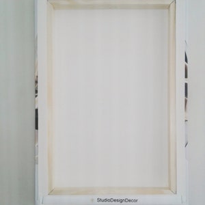 May include: White canvas print with a wooden frame. The back of the canvas has a label that reads "StudioDesignDecor".
