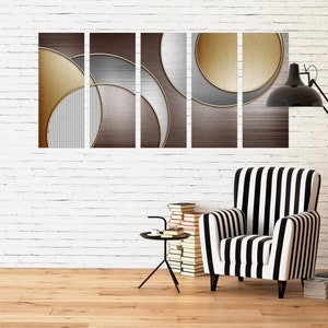 May include: A set of five abstract art prints with geometric shapes in shades of gold, brown, and gray. The prints are arranged in a row on a white brick wall above a black and white striped armchair.