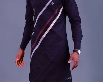 May include: A black long-sleeved shirt with a diagonal stripe design in white, brown, and gray. The shirt has a small crown logo on the chest and the text "ACW" on the bottom.