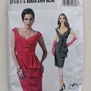 May include: A Butterick sewing pattern envelope featuring illustrations of two dresses. One dress is a solid red, the other is black with white polka dots. The envelope has the text "B5814 Butterick" at the top.