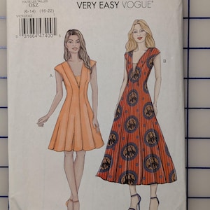 May include: Vogue sewing pattern V9292 featuring two dress designs. The pattern cover shows illustrations of the dresses, one in orange and the other in red with a circular pattern. The text "VERY EASY VOGUE" is at the top.