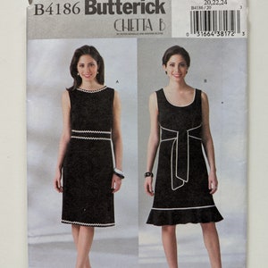 May include: A sewing pattern for two dresses, labeled B4186 Butterick Chetta B. The pattern includes two styles, one with a straight skirt and the other with a ruffled skirt. Both dresses have a white trim.