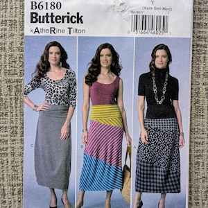 May include: A Butterick sewing pattern, B6180, featuring three skirt and top designs. The pattern includes a leopard print top, a tank top with a striped skirt, and a black turtleneck with a patterned skirt. The pattern size is Y (Xsm-Sml-Med).
