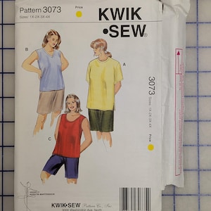May include: A Kwik Sew pattern packet, model 3073, featuring illustrations of tops and shorts. The packet includes sizes 1X-2X-3X-4X. The front of the packet displays the Kwik Sew logo and the designer's name.