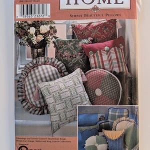 May include: A Simplicity Home sewing pattern envelope 8859 for pillows. The front features images of various decorative pillows with tassels, ruffles, and plaid or floral fabrics. Text includes Simplicity Home, Simply Beautiful Pillows, and Conso.