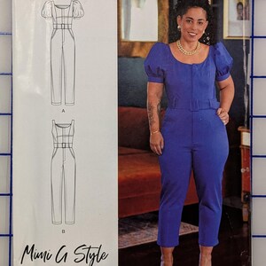 May include: Simplicity sewing pattern R10931 featuring a jumpsuit design with puff sleeves and a belted waist. The pattern includes sizes U.S. 6-14. The Mimi G Style pattern is shown on a blue grid background.